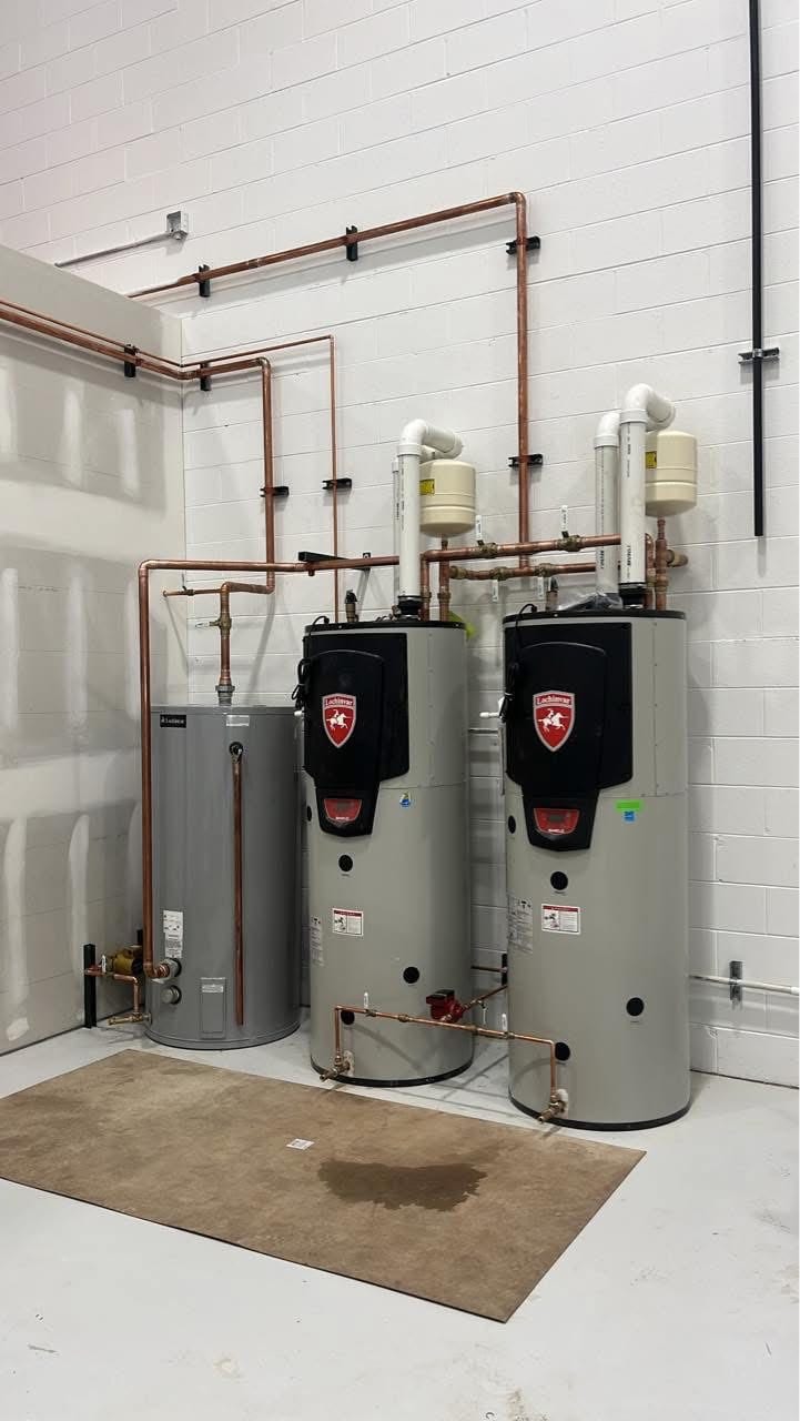 Commercial water heater pair with copper manifold, installed by Falcon Plumbing